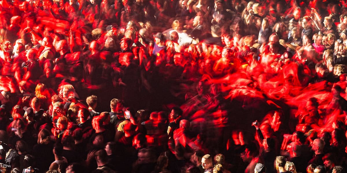 Long-exposure crowd at a packed arena rock concert