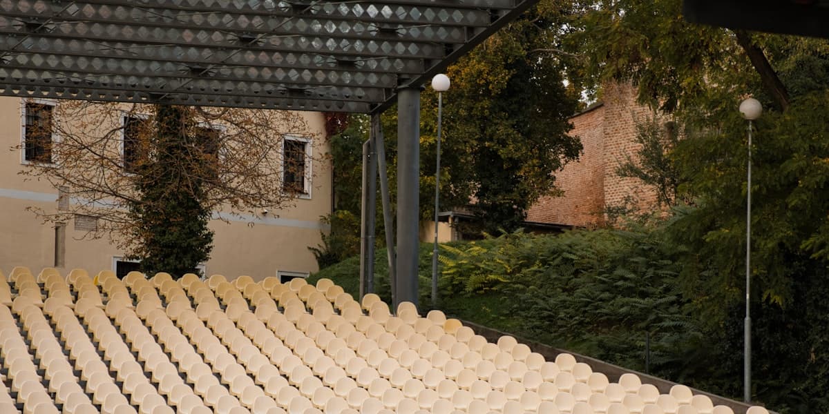 Empty outdoor amphitheater seating with the stage canopy overhead