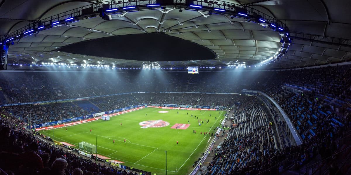 Aerial view of a floodlit football stadium at night
